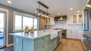 A beautiful modern kitchen with white countertops and blue kitchen island