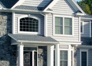 Front view of a beautiful suburban home with curved window and textured siding