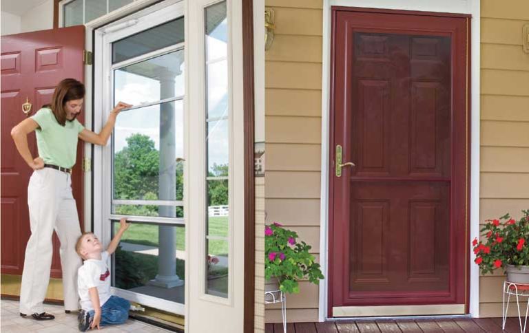 A mom stands with her son showing him the storm door that stands behind the front entry door to their home, with an image of the external red door next to it