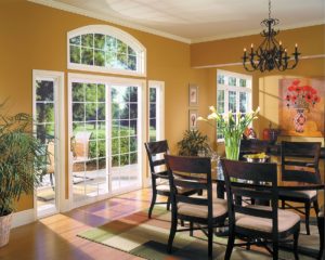 The dining area of a home with beautiful patio doors that lead outside to a patio area on a sunny day