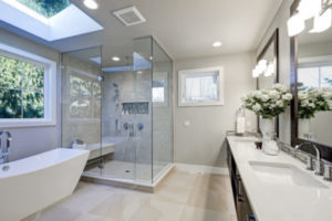 Spacious bathroom with tub walk-in shower double sink vanity and skylight