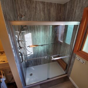 A beautiful glass shower with wooden fitting