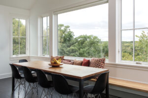 The dining area of a home with expansive windows