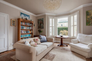The living area of a home with a beautiful bay window in the corner